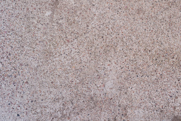 Grey beton texture with small stones background.