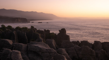 Unusual rock formations on ocean&acute;s coast shot during sunset, Picture made at Punakaiki Pancake Rocks, West Coast, New Zealand
