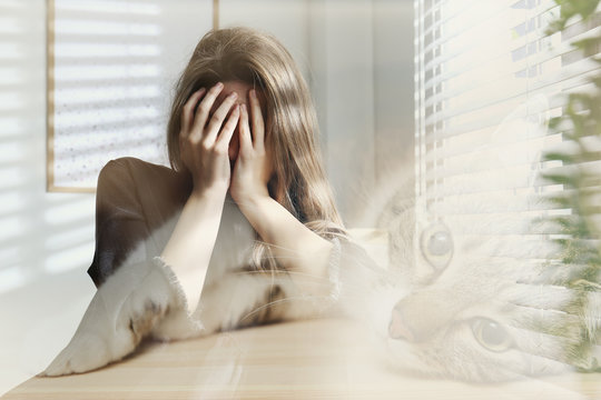 Woman suffering from ailurophobia indoors. Irrational fear of cats