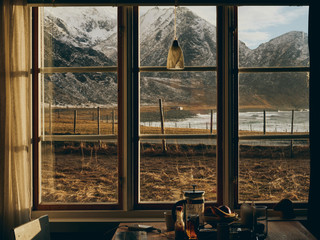 View from window with beach and mountain backdrop