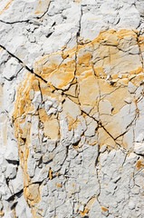 abstract texture of coastal white stone with red stripes for background, close-up