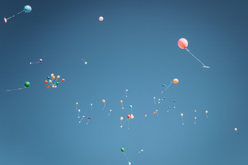 photo of colorful helium balloons flying in the sky