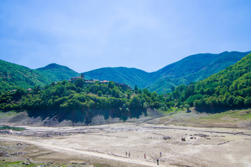 drought and temperature rise catastrophe, dry river and town without water.