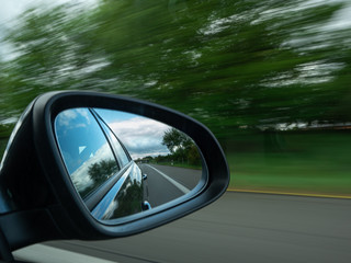 image of an exterior mirror while driving on the motorway