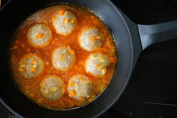appetizing meatballs in a sauce stew in a pan. Top view