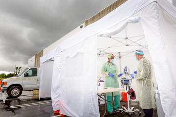 Frontline Epidemic Medical providers in Protective Gear Caring for Patients.