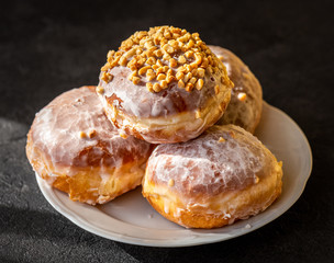 Many homemade donuts on a plate