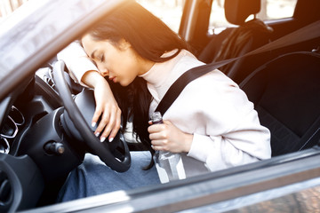 Drinking at the wheel. A drunk woman drives a car. Life threatening to drink alcohol and drive a...
