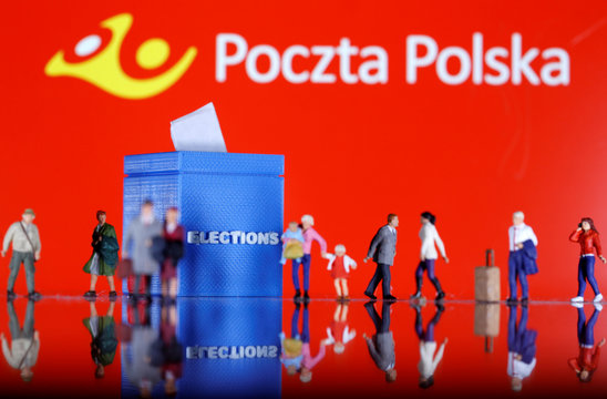 A 3D printed ballot box and toy people figures are seen in front of displayed Poczta Polska logo in this illustration