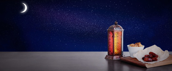Traditional Ramadan lantern and dry fruits on table, banner design. Muslim holiday