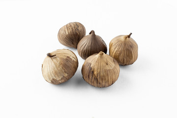 A group of black garlic, solo garlic bulb. A food ingredient, or commonly used for holistic food theraphy.