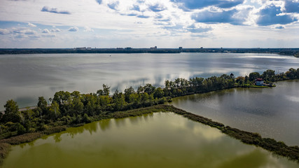 Aerial view of the lake in the middle climatic zone , roads and villages surrounding