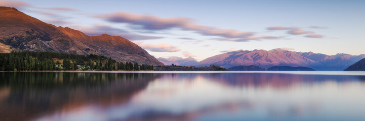 Sunrise Early Morning  Lake Landscape With Mountains. Lake Wanaka South Island New Zealand. Popular Travel Destination NZ. Colorful Sky and Landscape