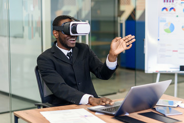 Portrait of young african american professional using augmented virtual reality in modern loft office. VR technology