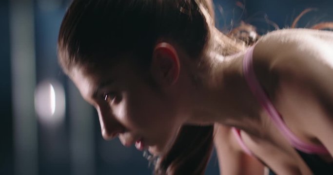 Young professional motivated active female athlete working out in gym, doing intensive push ups to increase her strength and achieve bodybuilding goals 4k footage