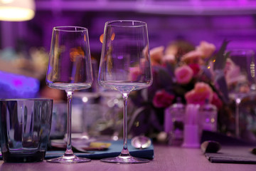 empty wine glasses on the table, purple shining with light