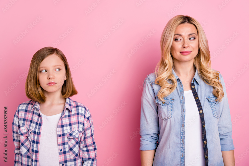 Poster portrait of minded woman girl mother daughter look each other wear casual style clothes isolated ove