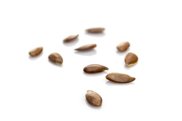 Linseed, flaxseed, linum seeds isolated on white. Healthy food pile background. Diet, vegetarian or clean eating concept. Macro close-up shot.