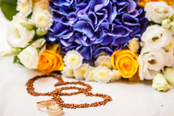 Wedding rings against the background of the bride's bouquet.