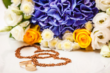 Wedding rings against the background of the bride's bouquet.