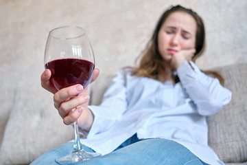 Girl drinks wine from grief due to job loss.