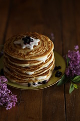 stack of pancakes on a plate with flower decor