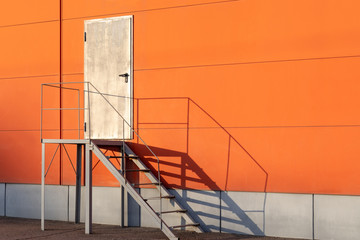 Iron staircase for up to maintenance work. Steel stair is on the side of the building wall.