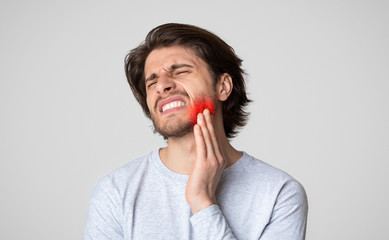 Teeth problem. Sad man suffering from tooth pain
