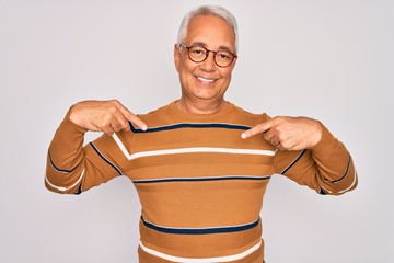 Middle age senior grey-haired handsome man wearing glasses and casual striped sweater looking...