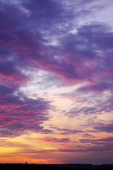 Naklejka na ściany i meble Deep sky above horizon. Bright sunset with clouds