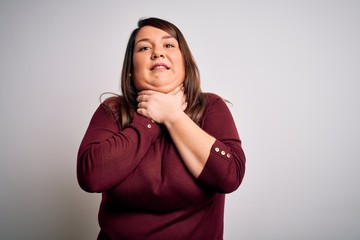 Beautiful brunette plus size woman wearing casual sweater over isolated white background shouting and suffocate because painful strangle. Health problem. Asphyxiate and suicide concept.