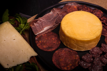 Cheese with serrano ham, olives on a table for a party with friends or as an aperitif