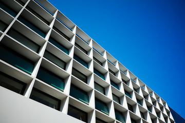 Cordoba, Argentina - January, 2020: Low angle view of office building against clear blue sky. Modern building architecture with abstract rectangle geometric patterns. Random unrecognizable building.