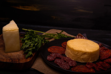 Cheese with serrano ham, olives on a table for a party with friends or as an aperitif