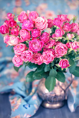 Close-up floral composition with a pink roses .Many beautiful fresh pink roses on a table.

