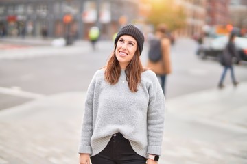 Young beautiful woman smiling happy and confident. Standing with smile on face walking at the city