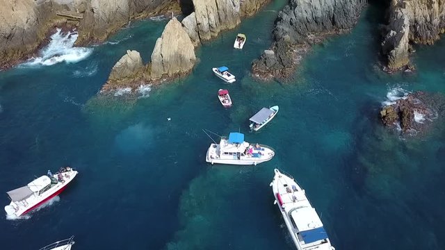 Aerial traveling out over some yachts in the Quebrada in Acapulco