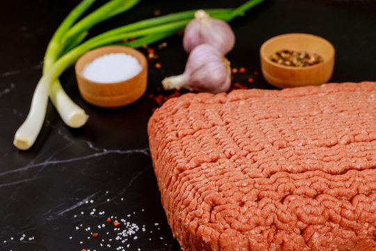 Ingredients for cooking meatball. Olive oil, garlic, minsed meat, pepper and fresh green onion.