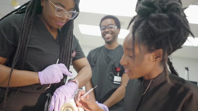 People working in a laboratory with dentures