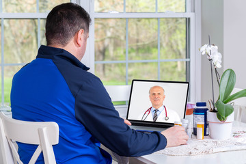 Sick Patient talking to a doctor online through a laptop