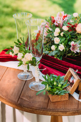 Box for wedding rings decorated with flowers stand on a wooden table during a wedding ceremony. Wedding decorations. Closeup details of a wedding decor