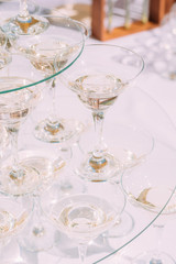 A pyramid of glasses of champagne. White sparkling wine in glasses.