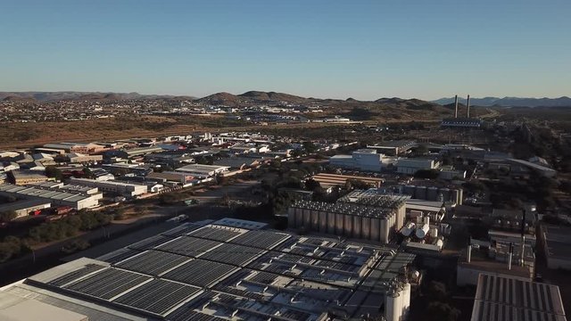 4K bright summer morning aerial video of Namibia Brewery beer factory and its hangars located in Windhoek Northern Industrial area, Khomas Region, central Namibia, southern Africa