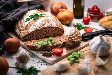 Obraz na płótnie Canvas Background with bread, rolls, vegetables and herbs