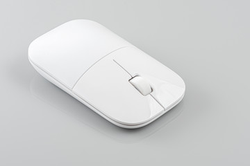 Wireless computer mouse on the gray background.