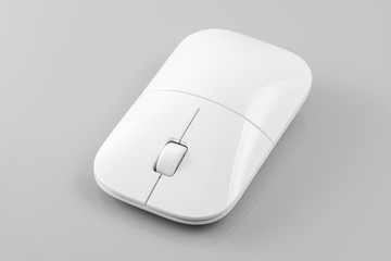 Wireless computer mouse on the gray background.