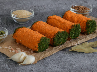 Meat rolls on a stone background