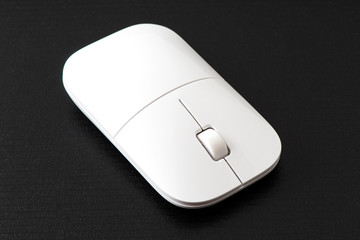 Wireless computer mouse on the black background.