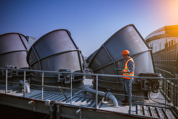 A engineer under checking the industry cooling tower air conditioner is water cooling tower air...