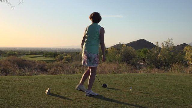 Woman Golfer Driving a Golf Ball